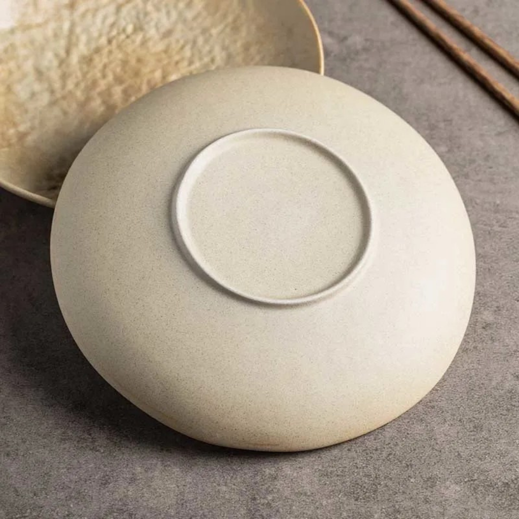 Base of handcrafted stone sand ceramic dinner plate showing smooth unglazed foot ring and quality ceramic finish