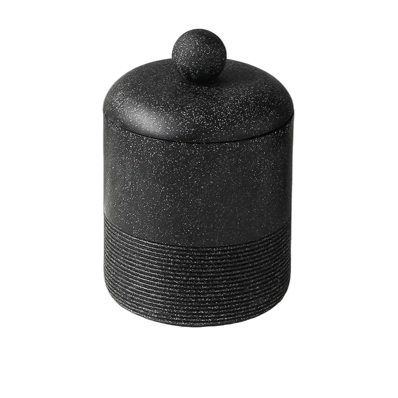 Midnight Stone wabi-sabi ceramic storage jar with domed lid and round ball knob, full front view on white background showing dark speckled stone texture and ribbed base detail