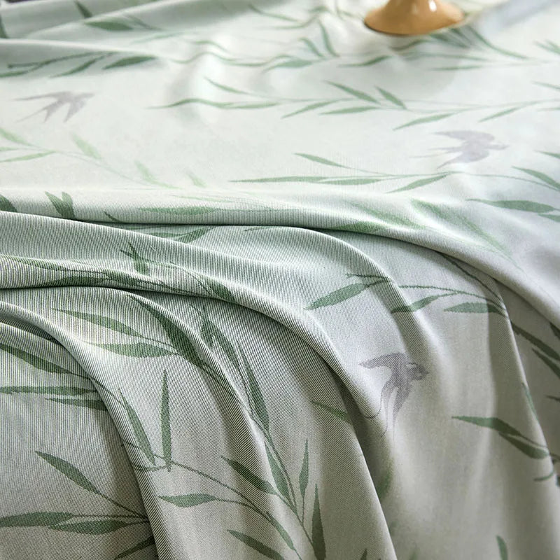 "Close-up of 100% Bamboo Fibre cooling blanket in Willow Mist — soft sage green willow leaf print showing the fine texture and breathable weave of the bamboo fabric"