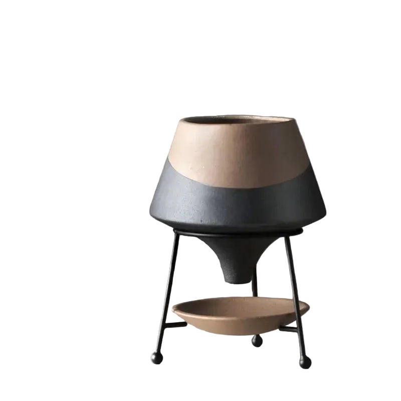 Slate and sand two-tone ceramic cone plant pot on matte black iron tripod stand with ceramic drainage saucer, matte anthracite and sand beige finish, grey background
