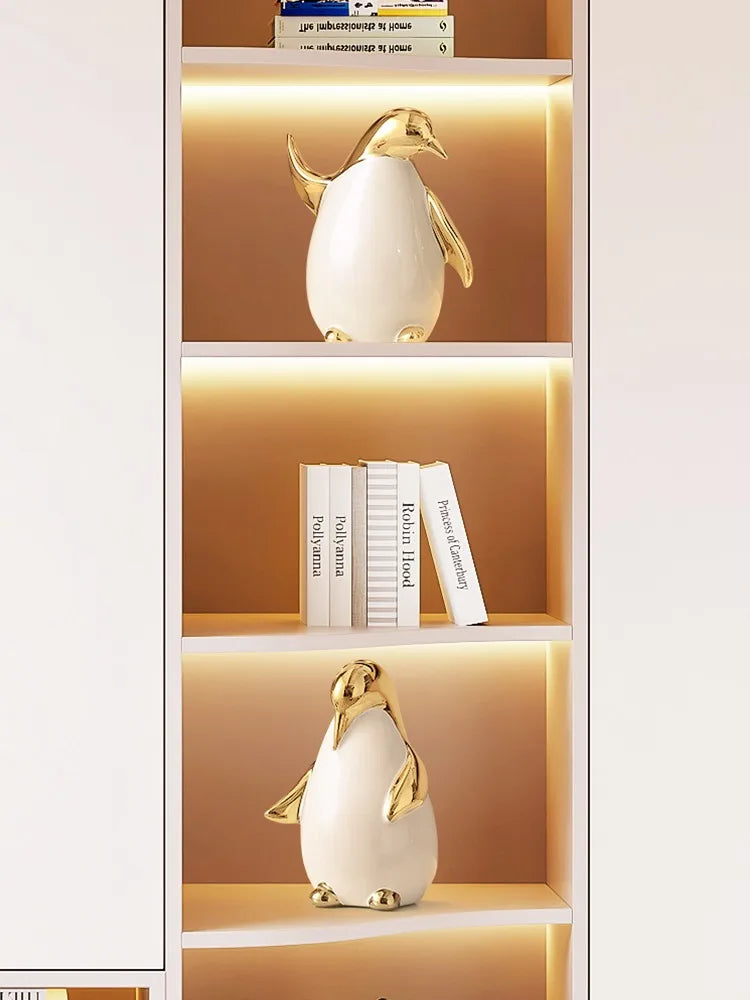 "Arctic Family" ceramic penguin styled on bookshelf, CL House