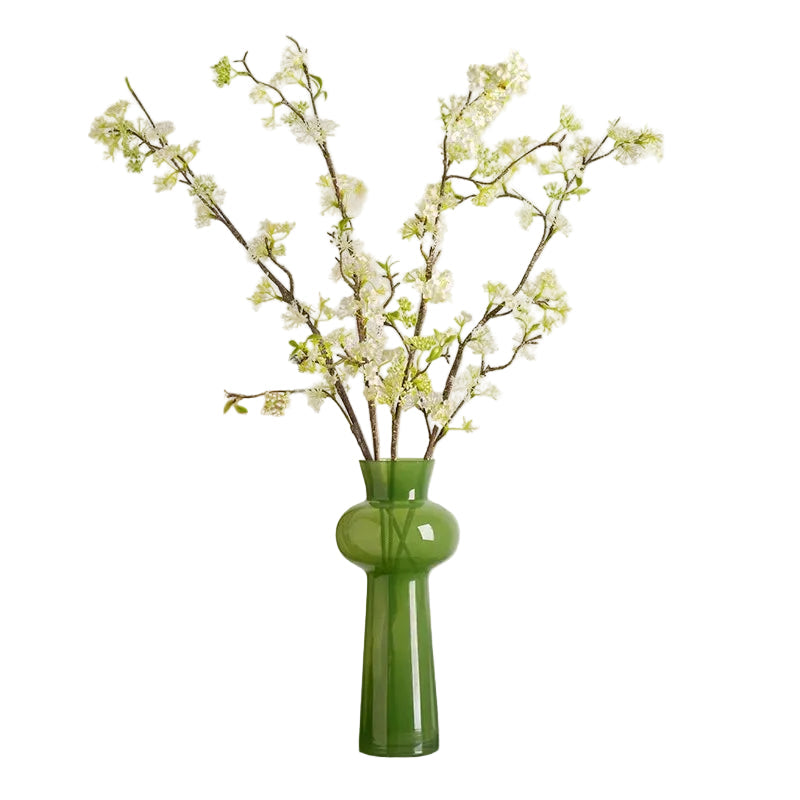 Moss Curve moss green glass vase styled with white cherry blossom branches, white background