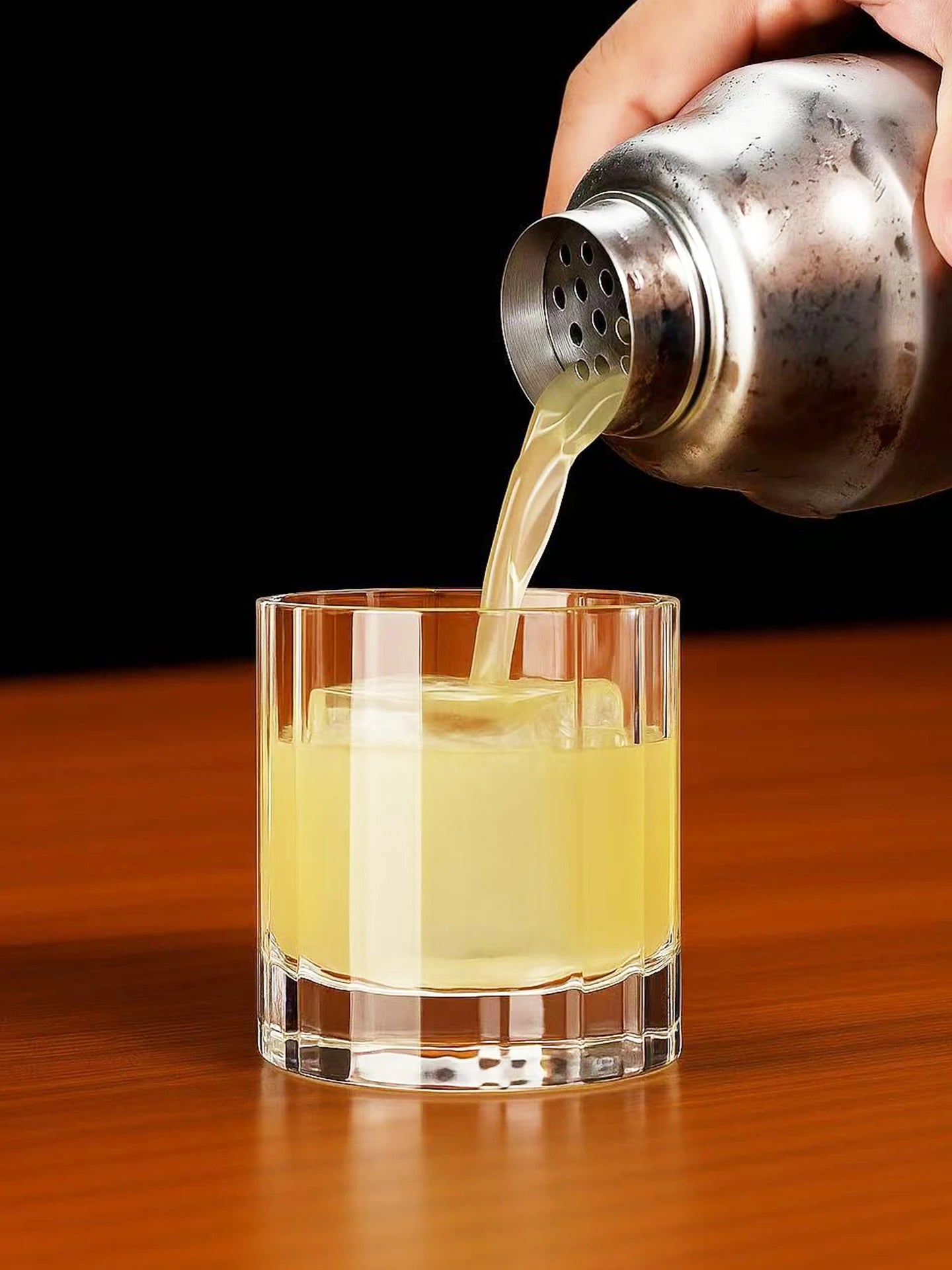 "Fluted Column" crystal rocks glass filled with a cocktail, elegant fluted column design — CL House Drinkware collection