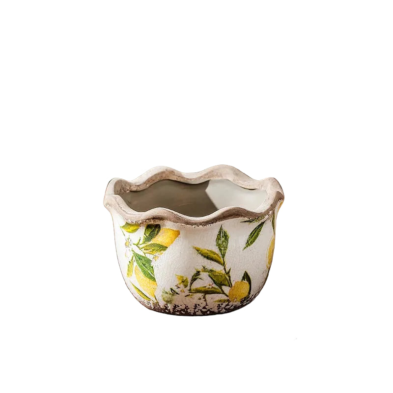 "Lemon Grove" hand-painted ceramic plant pot in Small size, white crackle glaze with yellow lemon and green leaf print, wavy scalloped rim, shown on a white background