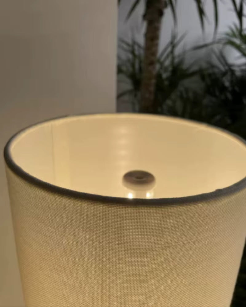 Close-up of the "Tripod & Cylinder" floor lamp fabric shade showing linen texture and touch switch detail