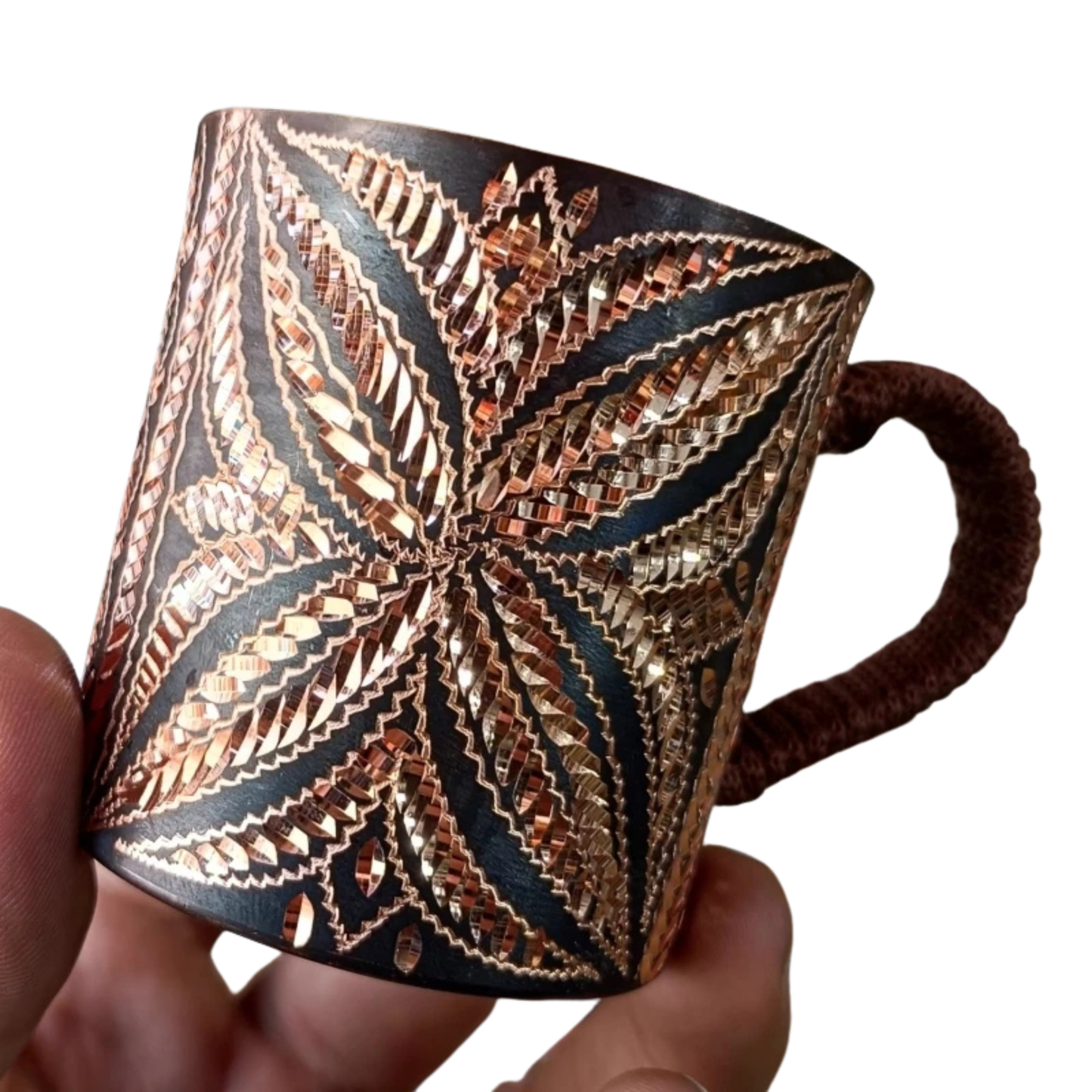 "Artisan's Mark" pure copper mug held in hand, close-up of engraved pattern — CL House