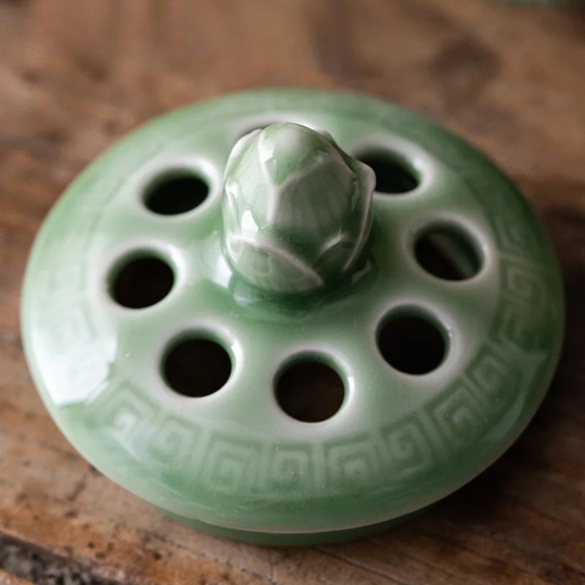 Perforated lid of Lotus Bloom ceramic incense burner — lotus petal detail in celadon — CL House