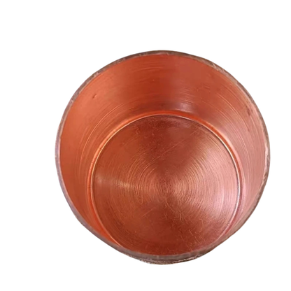 "Artisan's Mark" handcrafted copper mug held from below, full pattern detail — CL House