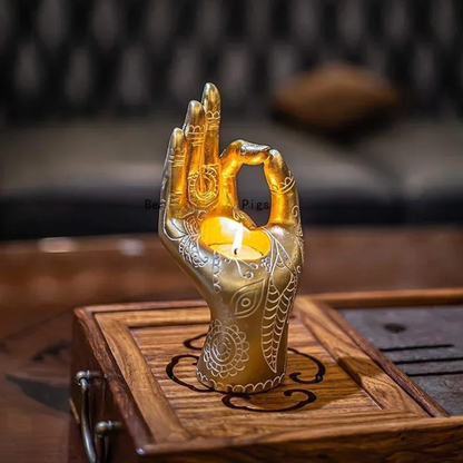 "Sacred Mudra" golden Buddha hand candle holder with lit tealight — mandala resin sculpture by CL House