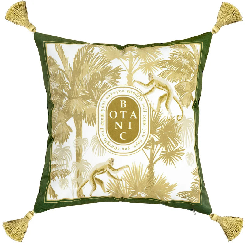 "Wild Kingdom" velvet cushion cover, Botanic Monkey design — white ground with golden palm trees and monkeys, dark green border, oval Botanic gold medallion at centre, gold corner tassels