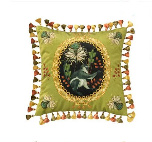 "Tropical Reverie" velvet cushion cover, Jungle Sovereign design — sage green ground with oval gold medallion, white bird and thistle bloom, floral corner embroidery, multicolour tassel trim