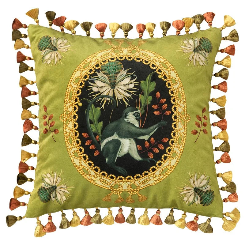 "Tropical Reverie" velvet cushion cover, Jungle Sovereign design — sage green ground with oval gold medallion, white bird and thistle bloom, floral corner embroidery, multicolour tassel trim