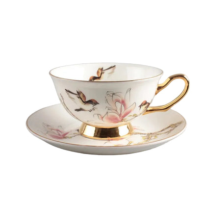Hummingbird:

"White bone china teacup and saucer with hummingbird in bloom print and gold trim, — CL House Tea Time"