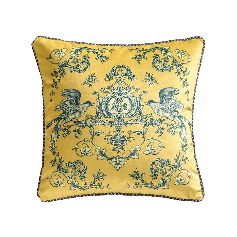  Velvet cushion cover, Twin Magpies design — golden yellow ground with symmetrical teal magpies perched on baroque scrollwork, floral garlands and ornamental vines, dark piping trim