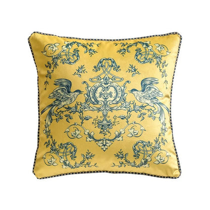 Velvet cushion cover, Twin Magpies design — golden yellow ground with symmetrical teal magpies perched on baroque scrollwork, floral garlands and ornamental vines, dark piping trim