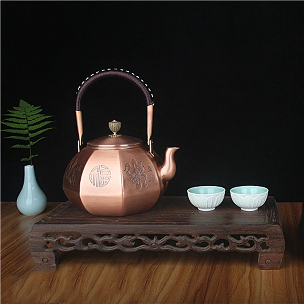 "Dynasty Forge" octagonal copper kettle styled with teacups and botanical vase on carved wooden tray — CL House