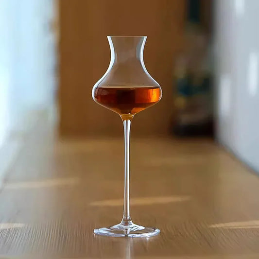  "Slender" crystal spirits glass filled with wine, placed on a table, sleek elongated silhouette — CL House Drinkware collection