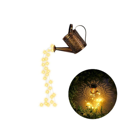 Starfall Kettle" solar fairy light watering can, Lattice Copper finish with geometric filigree pattern, warm LED fairy lights cascading from spout, shown on white background with night garden shadow projection inset