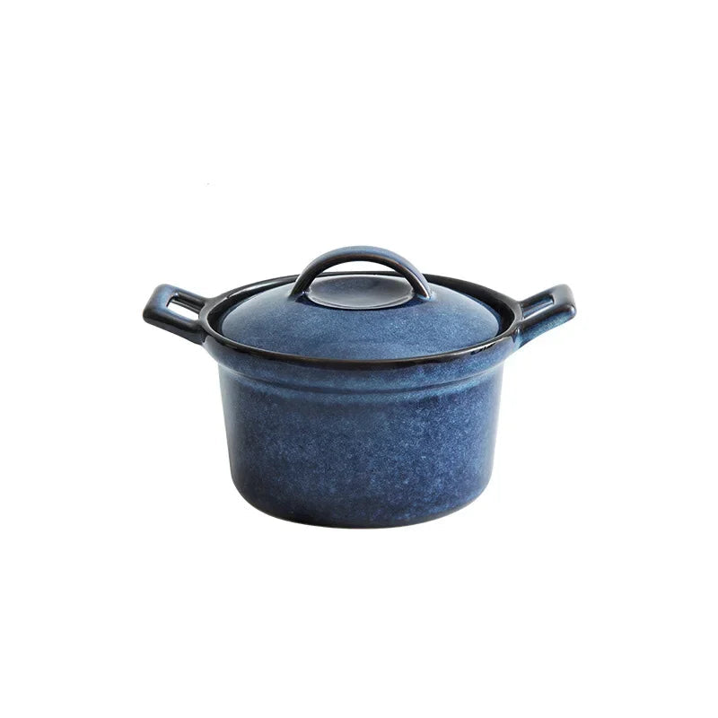 Reactive glaze ceramic casserole with lid, Midnight Blue finish — deep indigo speckled glaze, twin black handles, round knob lid, white background — Stone Vessel by CL House