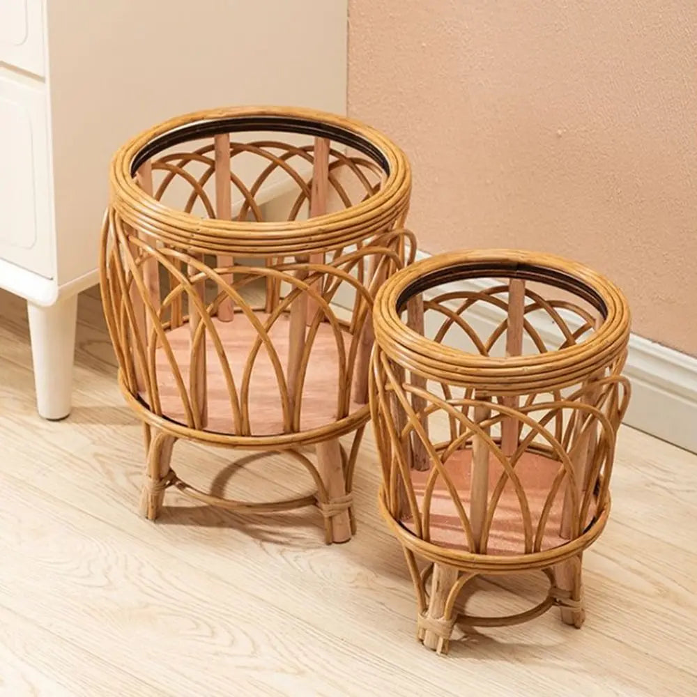 "Rattan Weave" natural rattan plant stands in Arch Weave Large and Small sizes styled together, glass top inserts, warm honey tone finish, against a terracotta wall on a light wood floor