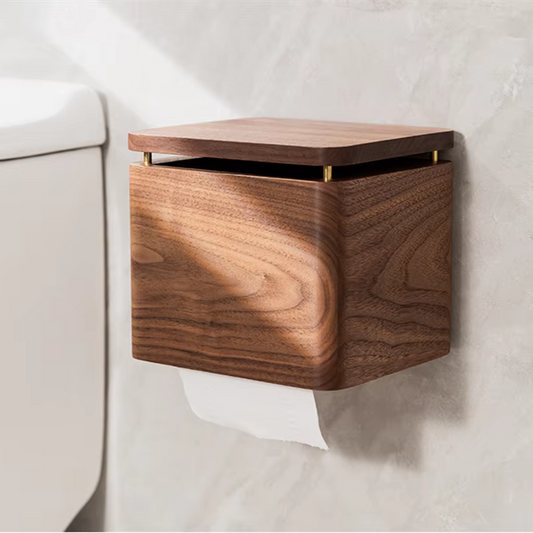  Walnut wood small tissue holder mounted on bathroom wall beside toilet, brass hinge detail, warm walnut grain texture, paper roll dispensing below — japandi bathroom accessory