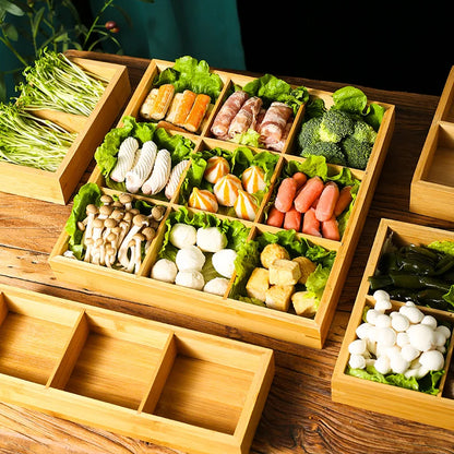 Bamboo Grid 9-section tray filled with colourful hot pot ingredients — mushrooms, tofu, fish balls, dumplings, vegetables and seafood — each compartment lined with fresh lettuce leaves, styled on a rustic wooden table