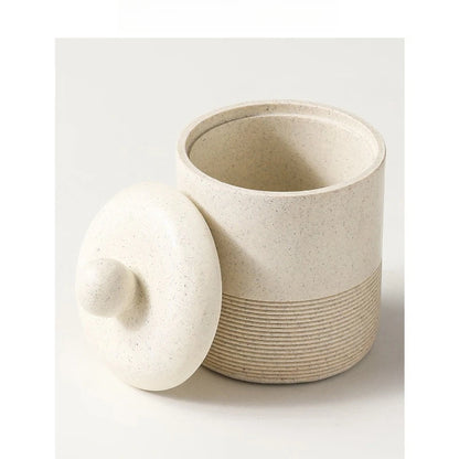  Chalk Stone ceramic storage jar open with lid resting beside it, showing smooth interior and ribbed base detail, angled view on light grey background