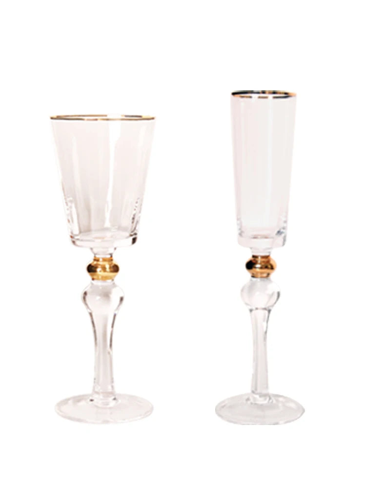  crystal wine glass and champagne flute side by side, featuring a gold filigree rim and delicate engraved band — CL House Drinkware collection