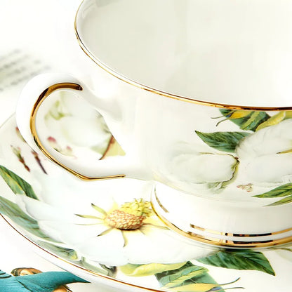 Close-up of "White Camellia" fine bone china tea cup showing gold rim, handle and camellia floral detail — CL House & Home