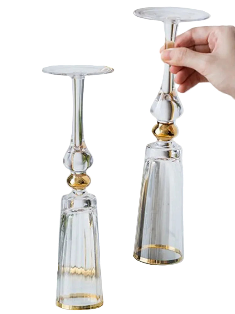 Two "Golden Hour" crystal glasses placed upside down, showcasing the gold filigree rim and elegant stem detail — CL House Drinkware collection