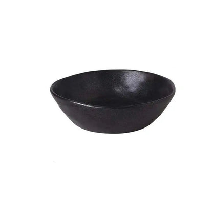  "Speckled Stone" ceramic serving bowl in matte black with speckled glaze texture — angled front view on white background