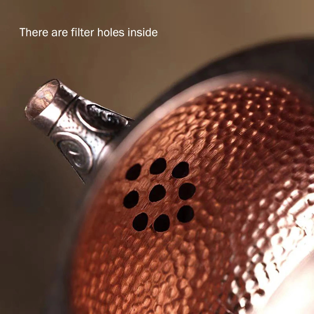 Close-up detail of handcrafted copper teapot handle — artisan teaware — CL House