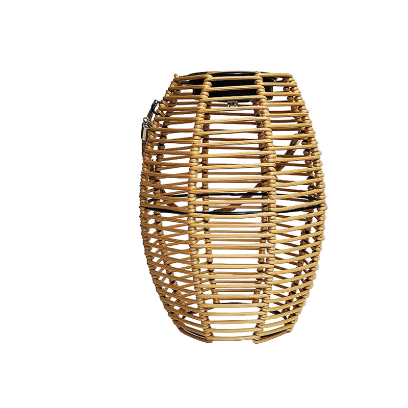 Rattan solar lantern in natural honey tone, oval barrel shape, with metal clasp handle — front view on white background