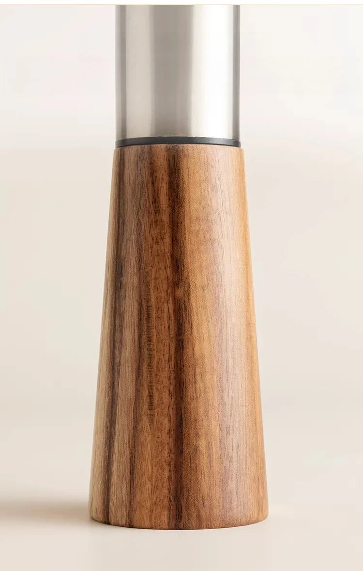 Acacia Twist mill close-up detail showing natural acacia wood grain texture and the junction with the brushed stainless steel mechanism
