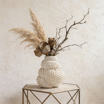 Coral Nest textured ceramic vase styled with pampas grass and dried branches on gold hexagonal side table, textured wall background