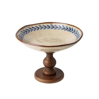  "Blue Botanics" ceramic pedestal serving stand with hand-painted willow leaf motif in soft blue, on a solid walnut wood turned base — white background
