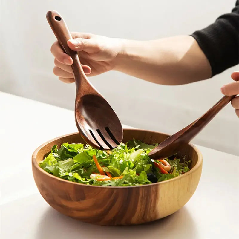 "Wild Harvest" acacia wood salad servers being used to toss fresh green salad in a wooden bowl, lifestyle kitchen scene