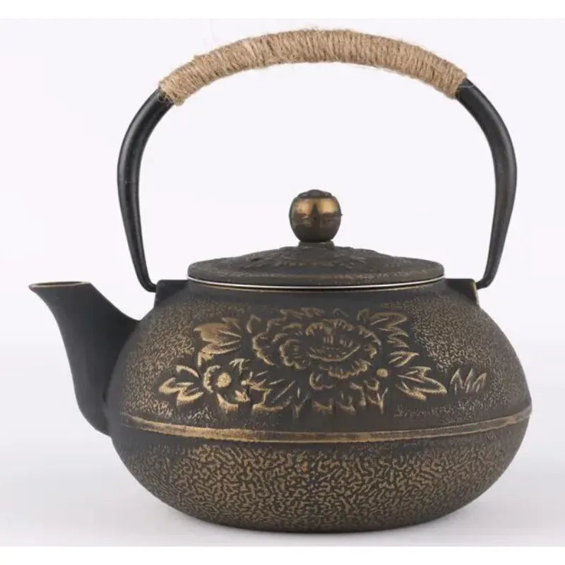  Cast iron teapot, Ancient Bronze finish — hand-engraved peony blossoms on warm bronze patina, rope-wrapped handle, round bronze lid knob, white background — Iron Ritual by CL House