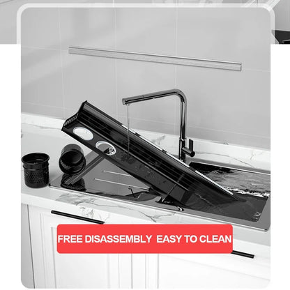  Matte black kitchen shelf disassembled and being rinsed under running water at a kitchen sink — organiser cup and drip basket separated alongside, demonstrating easy disassembly and cleaning maintenance