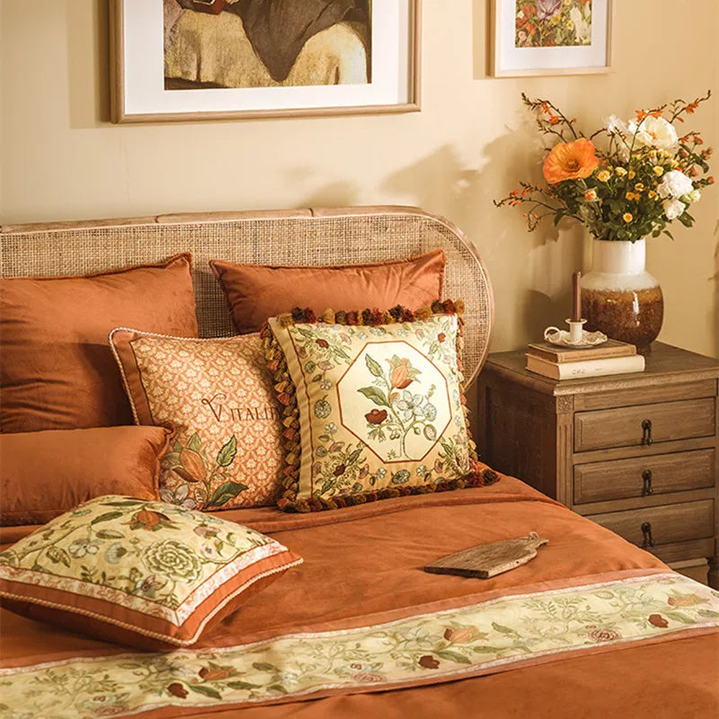 "Vitality" botanical embroidery cushion covers styled on a terracotta bedroom with rattan headboard and autumn floral arrangement — CL House & Home