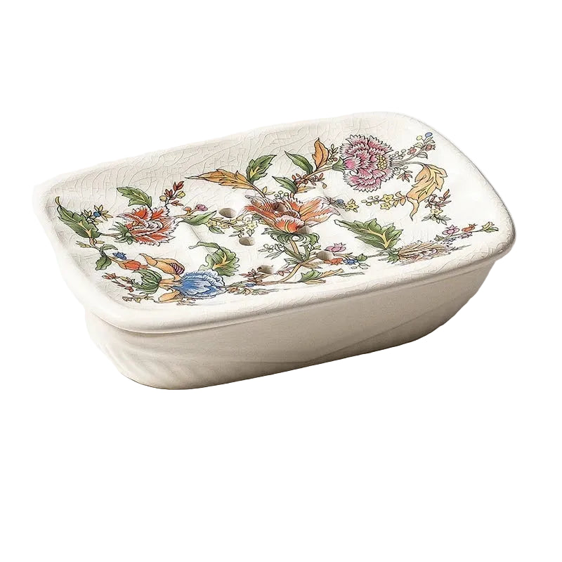 Rectangular flat ceramic soap dish with colourful botanical garden bloom print and drainage holes, angled view on white background