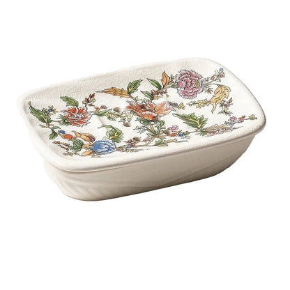 Rectangular flat ceramic soap dish with colourful botanical garden bloom print and drainage holes, angled view on white background