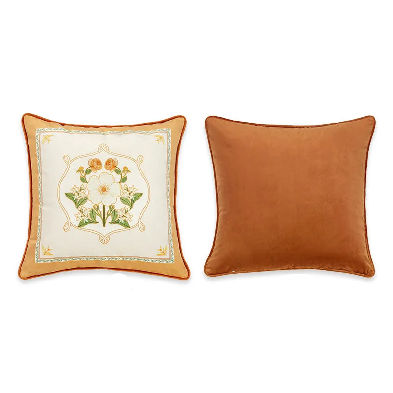  "Garden Rose" botanical velvet cushion cover front and back view, cream and caramel ground with central bouquet of white rose, orange roses and lilies in an ornamental braided frame, plain caramel velvet reverse with orange piping — CL House Cushions collection
