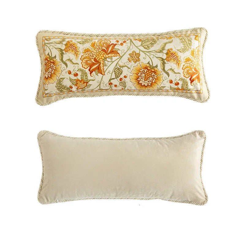 "Amber Bloom" lumbar cushion cover front and back view, ivory velvet with dense amber and gold floral embroidery, braided edge trim, plain ivory reverse — CL House Cushions collection