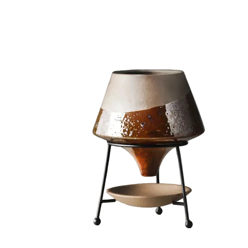  Amber reactive glaze ceramic cone plant pot on matte black iron tripod stand with ceramic drainage saucer, rich brown and silver glaze detail, grey background