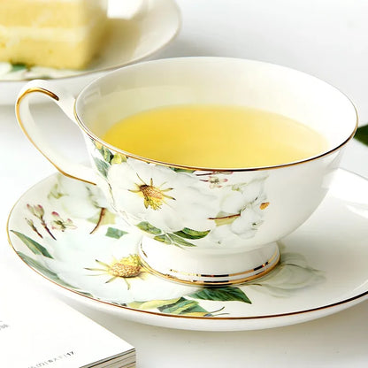 "White Camellia" fine bone china tea cup filled with golden tea, styled with a red rose — CL House & Home