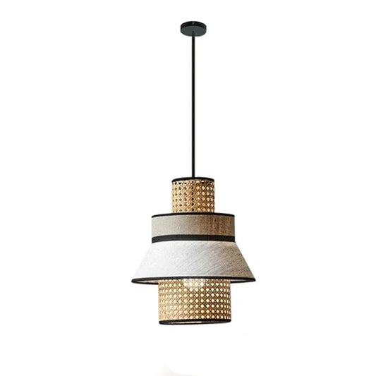 "Layer & Loom" tiered rattan and linen pendant light with alternating woven rattan and white linen rings, matte black frame, white background