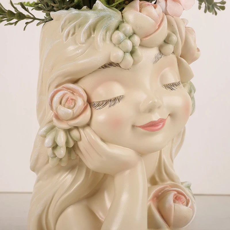 Rose Muse" resin fairy head planter in Blush Cream — macro detail of hand-painted face, rose and berry crown with mixed succulents