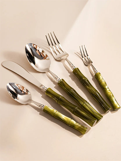  "Jade Stem" Sage Green cutlery set — 5 pieces arranged on a warm beige surface with soft natural shadows, showing the sculpted resin bamboo-style handles — lifestyle product shot