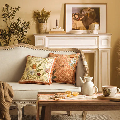 Golden Botanical and Vitality Terracotta cushion covers styled on a cream French sofa with tea set and fireplace mantel — CL House & Home